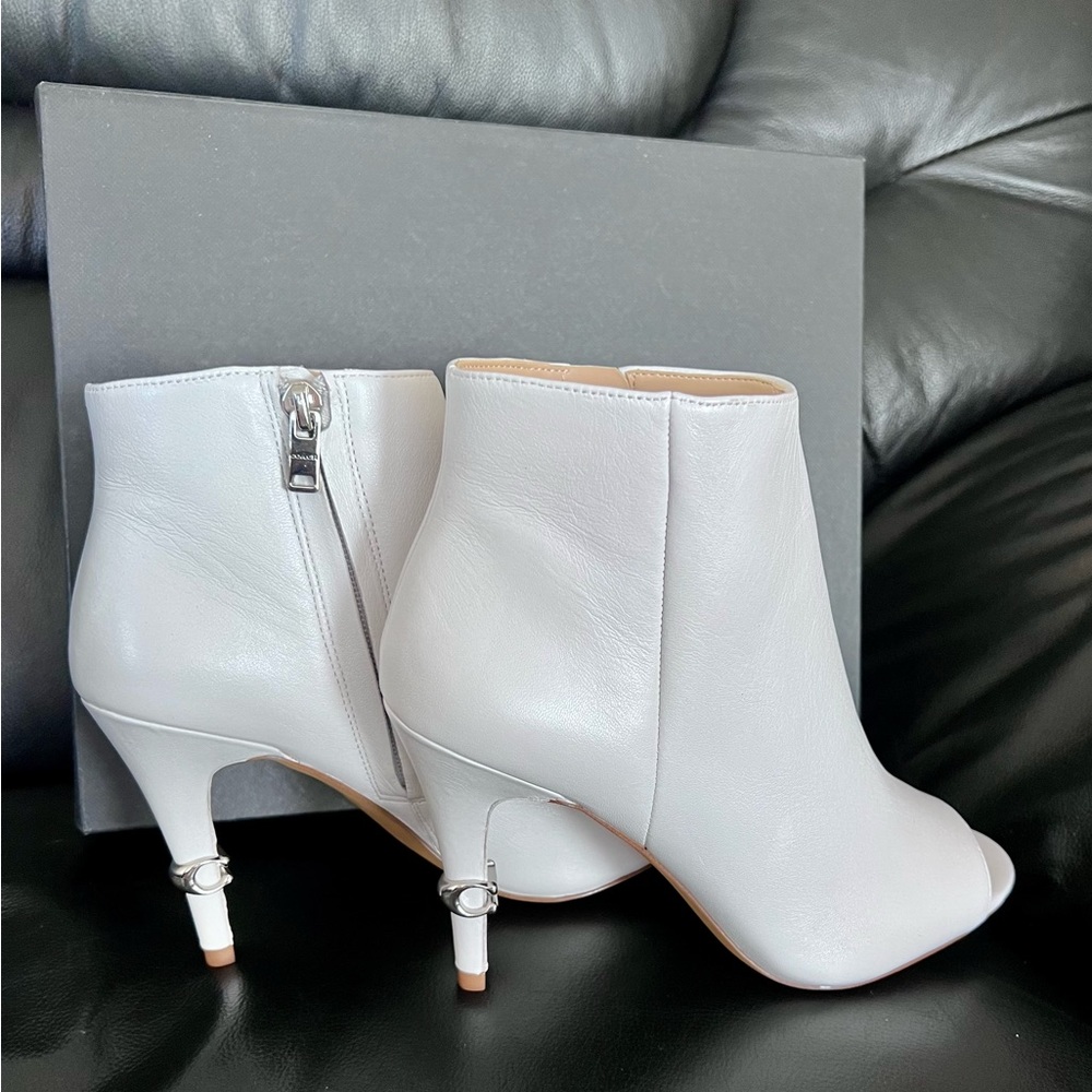 Brand new in box. Coach white leather bootie. Size 7B,  3 inches heel height.